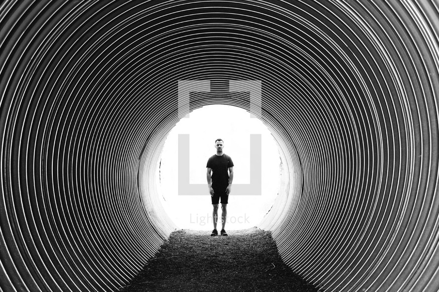 a man standing in a tunnel 
