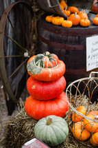 stacked pumpkins and wagon wheel 