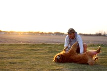 a man playing with his dog 
