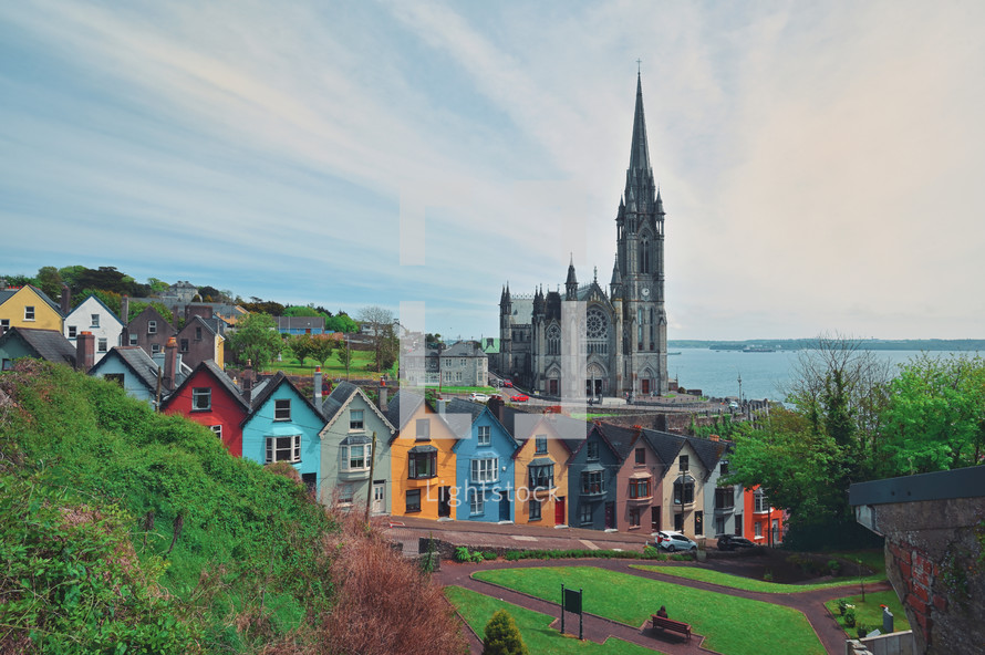 St. Colman's Cathedral And Colored Houses In Cobh, Ireland in Summer