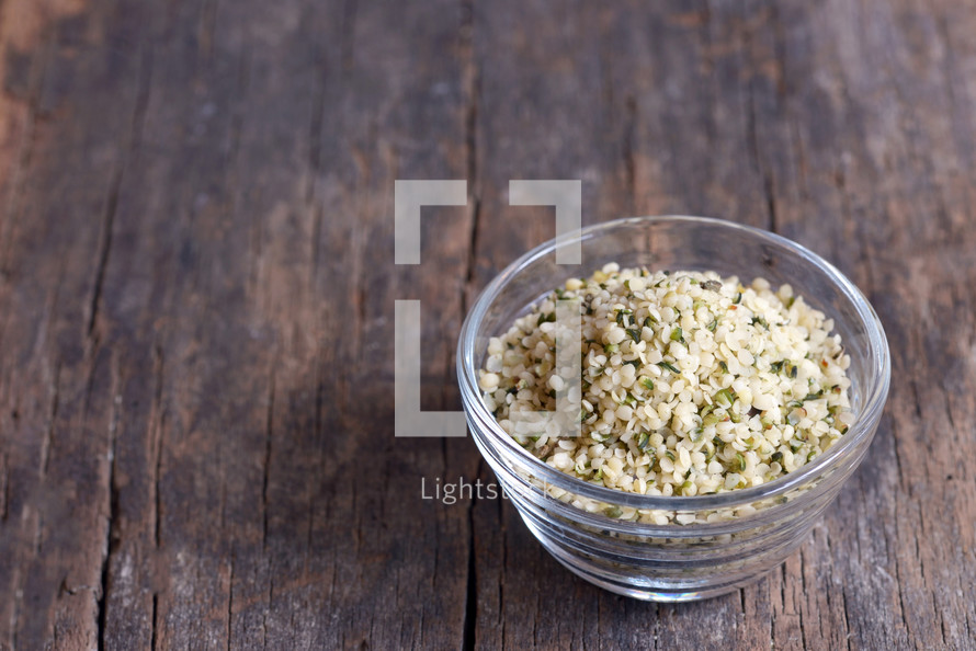 Organic Hulled Hemp Seeds in a Bowl on wooden table