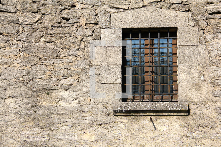 Barred window on castle wall