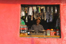 smiling man in a store window 