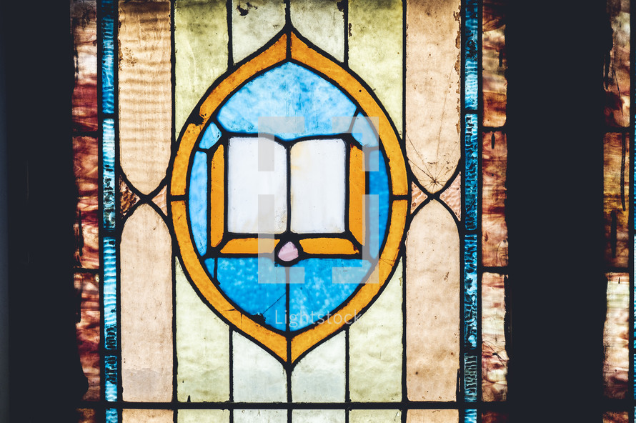 stained glass window with Bible 