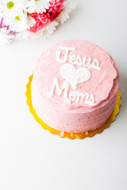 Bouquet of colorful flowers with "Jesus Loves Mom" cake.