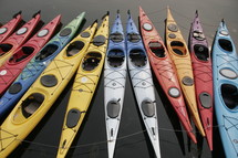 Colorful kayaks in the water.