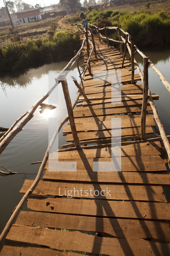 A modest walking bridge over a river in Malawi, Africa. 