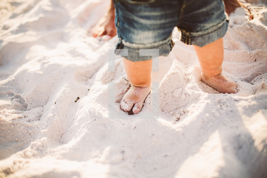 Toddler's feet in the sand.