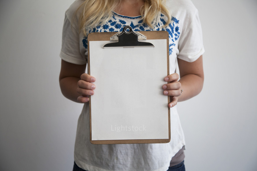 woman holding a blank clipboard 