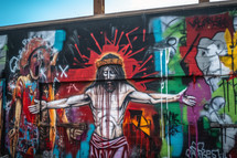A graffiti wall depicting Jesus dying on the cross for our sins.
