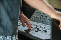 man controlling a soundboard 