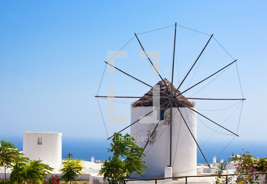 Traditional Santorini windmill against a blue sky