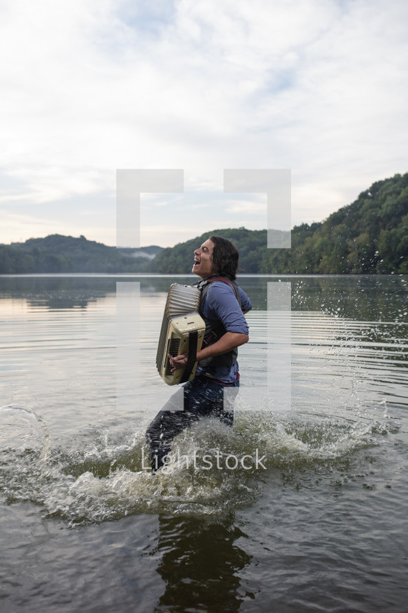 a man playing an accordion in a lake 