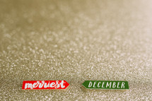 merriest, December on gold glitter 