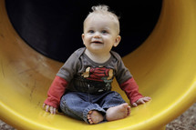 infant boy on a slide 
