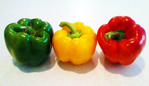 A collection of Green, Yellow and Red Bell Peppers adorning a Kitchen Counter top to be used in a delicious salad or healthy and vitamin enriched meal. Colorful produce is healthy produce. Something that we need to teach our kids as more and more of the foods we buy are injected with additives, chemicals and things that are unhealthy for us to consume and are making us sick. As a generation of people sick with cancer, heart disease and other diseases, there has never been a better time to turn back to the garden to eat health meals that can prolong our health and give us the kind of nutrition that God intended for us to have. 