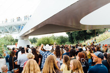 crowds at an outdoor worship service 