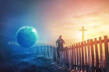 A man sits on a fence undecided between the earth and the cross.