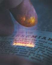 A finger reaches down to a Bible verse that says "I knew thee" with a glowing fingerprint.