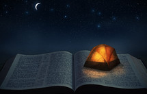 a tent on an open Bible 