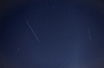 Meteors streaking across the night sky during a meteor shower