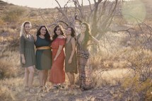 women's standing together in a desert 