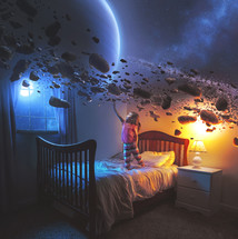 A little girl uses her imagination in her bedroom to see the rings of Saturn