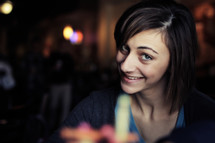 woman in a restaurant smiling