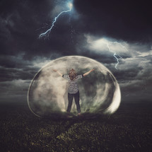 woman in a protective bubble in a thunderstorm 