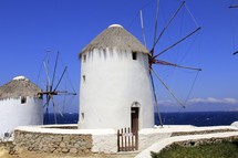 White washed wind mills on the shore line of Mykonos