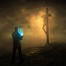 a man texting in front of Jesus on the cross