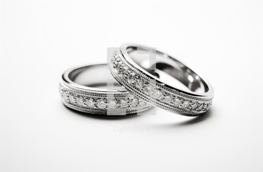 A close-up macro shot of two rings on a table against a white background