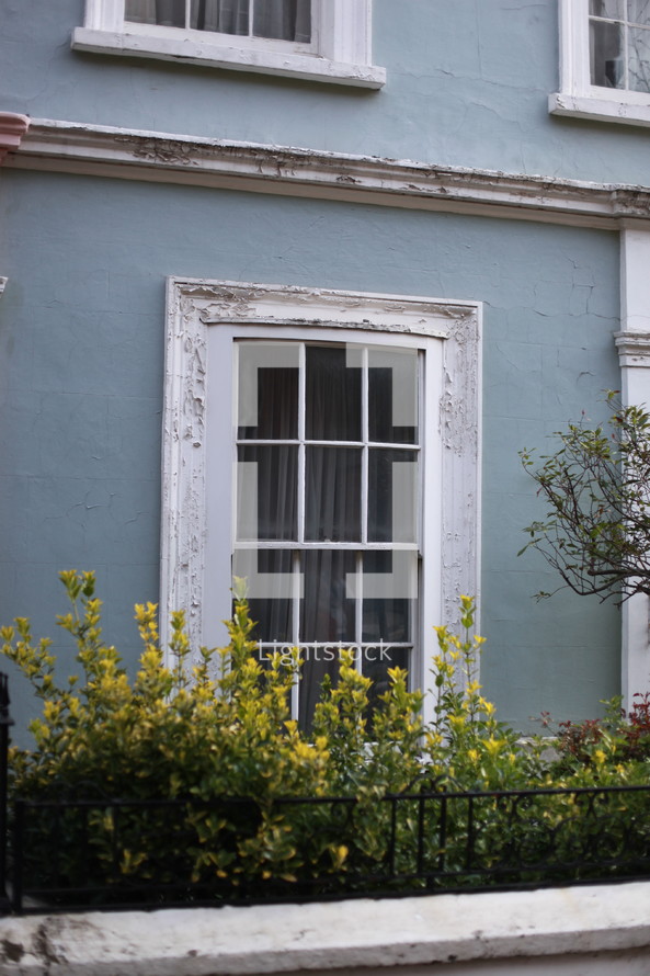 window on a blue row house 