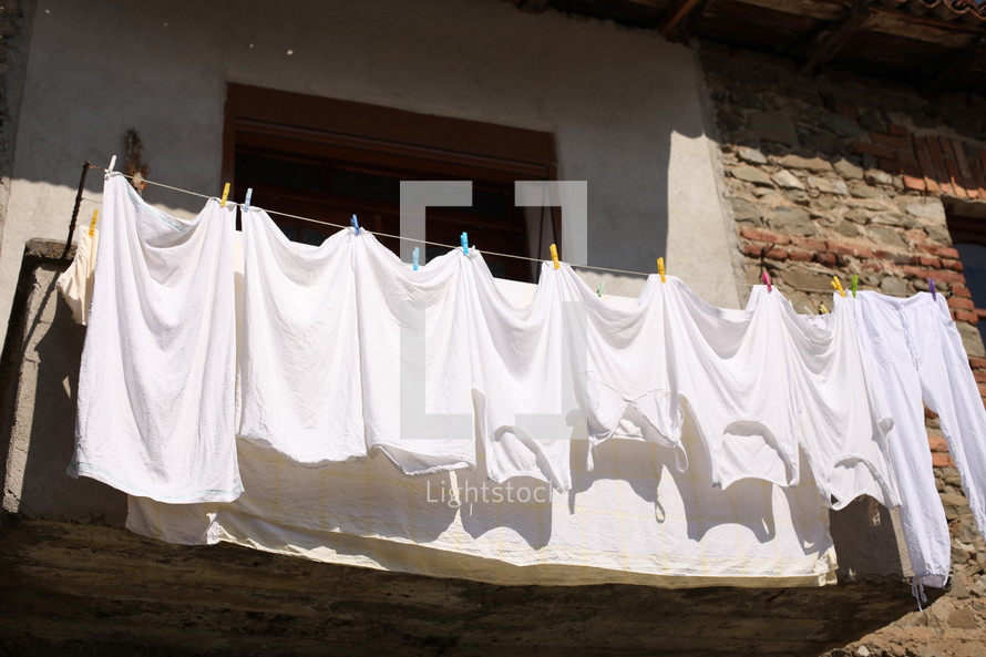 white clothes hanging on a clothes line 