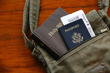 Mission trip, passport, sling bag, air ticket and Bible on a wooden background 