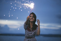 woman holding a sparkler 