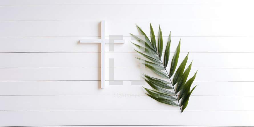 Palm Sunday. Cross and palm leaf on white wooden background with copy space
