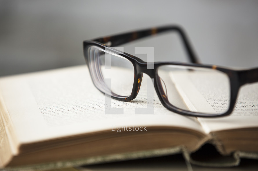 reading glasses on an old book 
