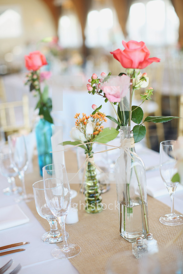 flowers in vases on a reception table 
