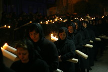 procession of people carrying crosses 