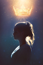 A woman in silhouette with a glowing crown above her head.