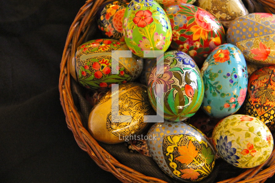 Decorative hand made wooden painted easter eggs in a basket