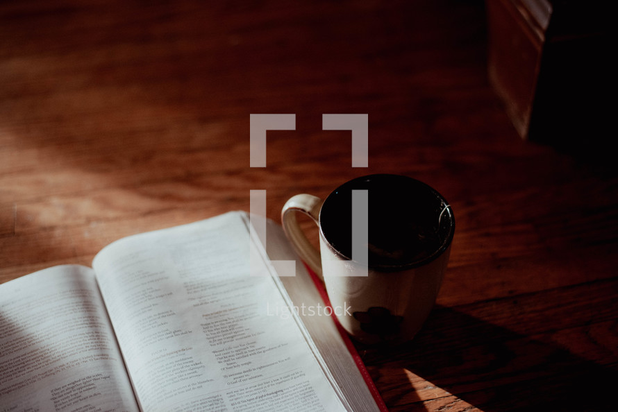 open Bible and coffee mug 