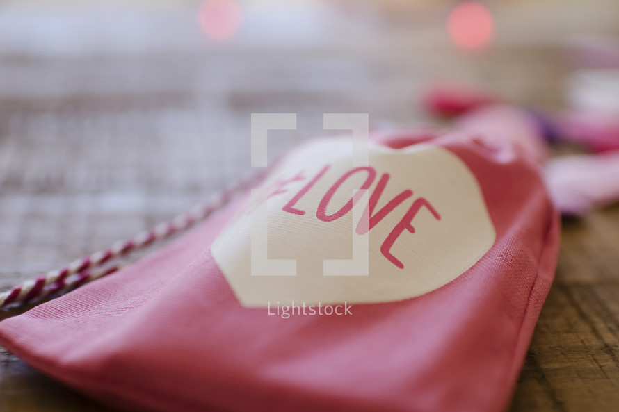 a cloth baggie with the word love