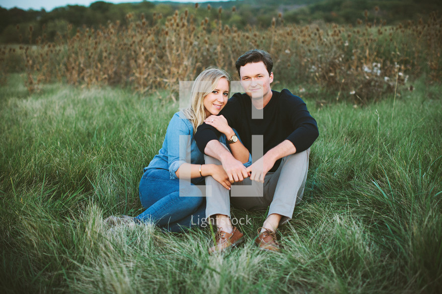 couple sitting in grass 
