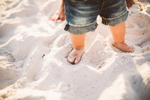 Toddler's feet in the sand.