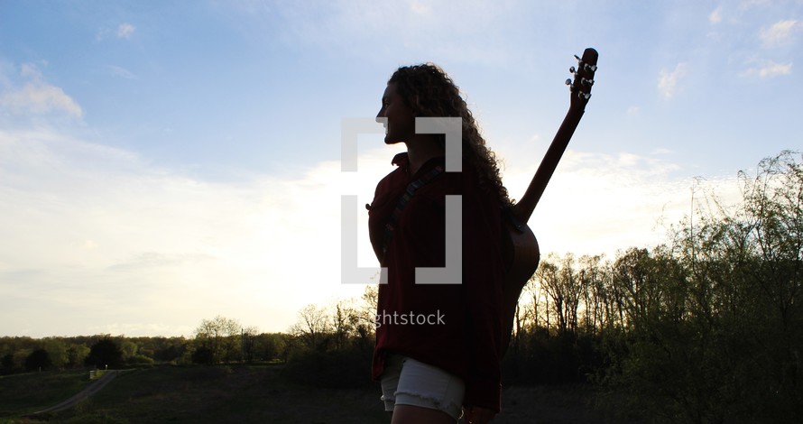 a girl with a guitar on her back 