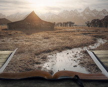 stream flowing into an open Bible and barn 