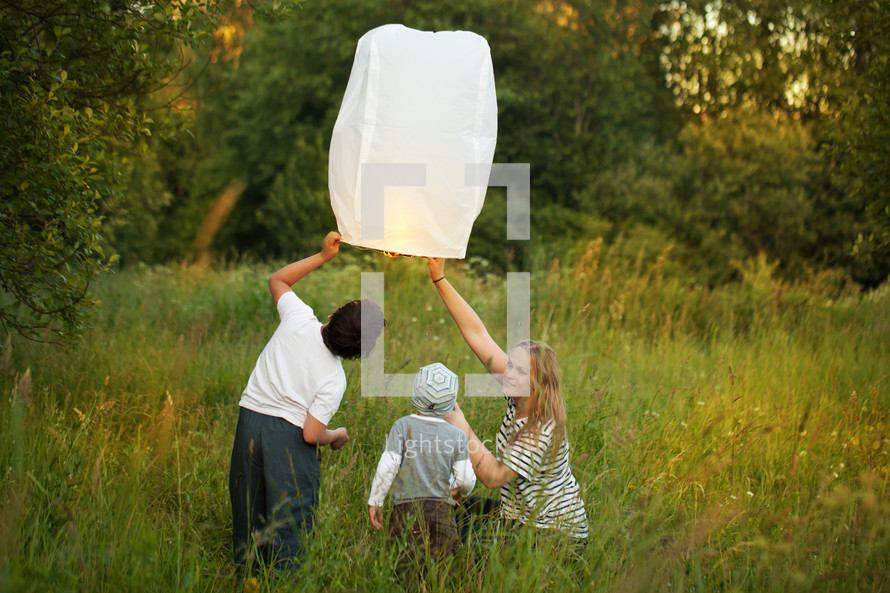 Mother with her sons flying paper lantern