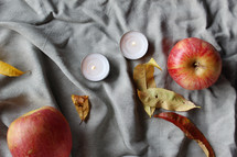 apples, fall leaves, and tea candles 